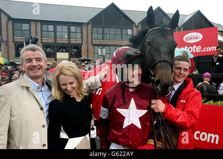 Sir des champs avec le jockey Davy Russell, le propriétaire Michael O'Leary (à gauche) et sa femme Anita après avoir remporté la coupe d'or TheTote.com Puncharown Steeplechase pendant la journée de la coupe d'or au Festival 2013 à l'hippodrome de Puncharown, Co Kildare, Irlande. Banque D'Images