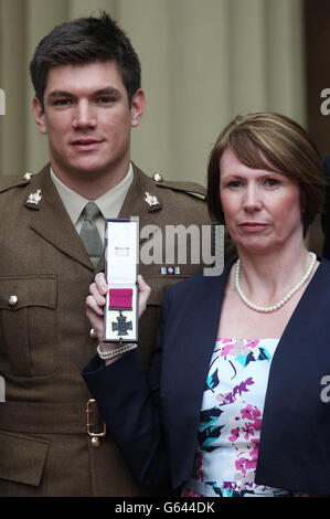 Mme Kerry Ashworth, qui a reçu la Croix de Victoria, a conféré à son défunt fils, le caporal James Ashworth, au Palais de Buckingham, avec son autre fils Coran. Banque D'Images