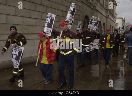 Les pompiers d'Islington et de Clerkenwell marchent vers Downing Street dans le centre de Londres alors qu'ils protestent le premier jour d'une grève nationale de huit jours. Le Syndicat des pompiers (FBU) et les employeurs sont toujours dans un conflit sur la rémunération et la modernisation. Banque D'Images