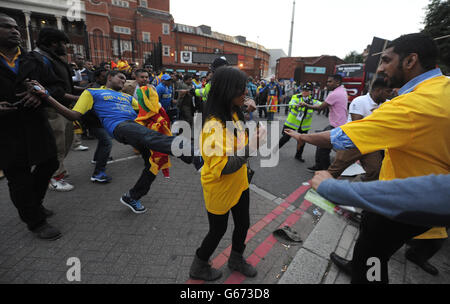 Les fans de cricket sri lankais s'affrontent avec la police et les manifestants du Sri Lanka qui a été expulsé du groupe de protestation du Commonwealth après le match du Trophée des champions de la CPI à l'Oval, à Londres. Banque D'Images