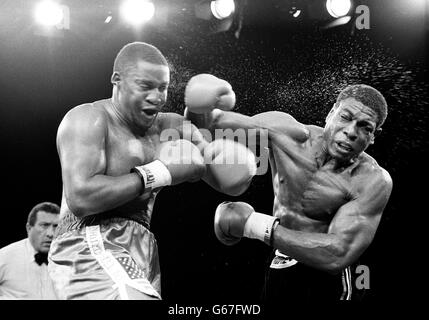 Frank Bruno, à droite, et le champion du monde de poids lourd de WBA Tim Witherspoon tous les deux poinçons simultanément pendant leur affrontement. Witherspoon de Philadelphie, USA a conservé son titre après que l'arbitre ait arrêté le combat au 11ème tour et Bruno a été hospitalisé pour une radiographie à sa mâchoire. Banque D'Images