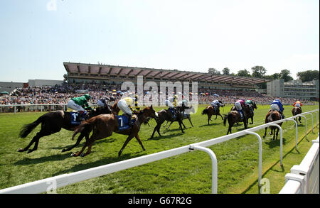 Une vue générale du terrain lorsqu'ils passent devant le Grand stand dans le Coral Challenge lors de la journée Coral-Eclipse à l'hippodrome de Sandown Banque D'Images