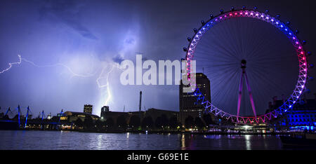 La foudre frappe derrière le London Eye à Londres, qui est de couleur rouge, blanc et bleu pour marquer la naissance d'un bébé garçon à 16h24 hier au duc et à la duchesse de Cambridge à l'hôpital St Mary's. Banque D'Images