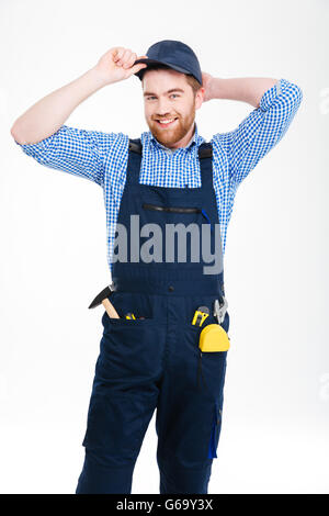 Happy handyman barbu standing and smiling Banque D'Images