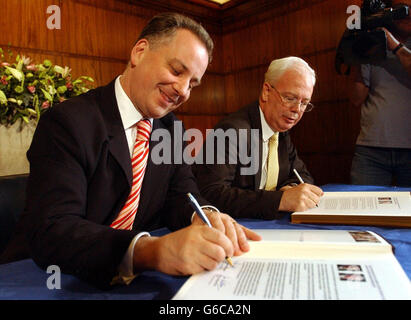 Le chef travailliste écossais Jack McConnell (à gauche) et le chef libéral Jim Wallace signent un accord de partenariat dans le cadre de l'accord de coalition. Banque D'Images