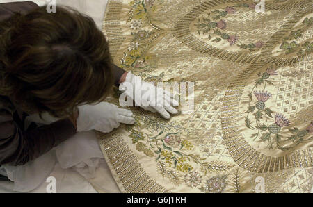 La robe de couronnement et la robe de domaine de la reine Elizabeth II sont à la charge de Sally Andrew, la conservatrice textile principale des Palais royaux historiques de Hampton court, avant que la robe et la robe ne soient exposées au château de Windsor le 8 octobre jusqu'au 4 janvier 2004,Lundi 6 octobre 2003.En raison de l'attrait populaire de la cérémonie et de la célébration: Couronnement jour 1953 à l'ouverture d'été de la salle de l'état à Buckingham Palace (ouvert jusqu'au 28 septembre 2003) ces robes continueront à être exposées jusqu'à la fin de l'année du couronnement dans la salle du trône de Garter à Windsor Castle. Banque D'Images