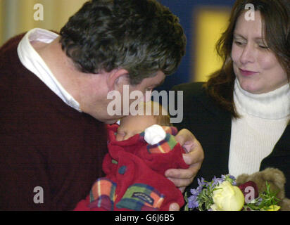 Le chancelier Gordon Brown embrasse son fils John comme il se tient avec sa femme Sarah, à l'infirmerie royale d'Édimbourg. Le fils nouveau-né du chancelier, John Brown, est né le vendredi 17 octobre 2003. Les nouveaux parents étaient enrayés de joie alors qu'ils posaient des photos avant de partir vers leur maison à North Queensferry. 6/12/03: Brown a dit au journal Sun comment sa nouvelle vie de père met un printemps dans son pas chaque matin. Mais il a dit qu'il devait prendre des leçons de changement de couche avant que le personnel de l'hôpital n'autorise Sarah, 39 ans, à Rentre à la maison. Malgré les nuits blanches, M. Brown, 52 ans, a dit qu'il essayait de le faire Banque D'Images