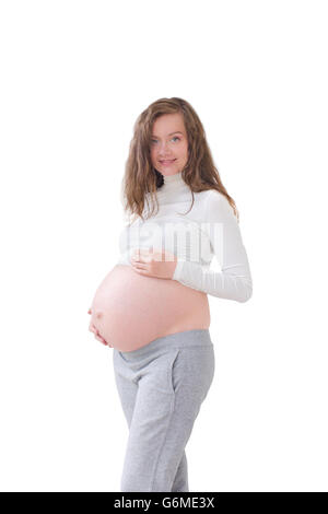 Femme enceinte en caressant son ventre isolé Banque D'Images