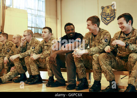 Le boxeur poids lourd Dereck Chisora avec des membres du 2e régiment du bataillon Princess of Wales pendant l'entraînement à la caserne de l'Artillerie royale de Londres. Banque D'Images