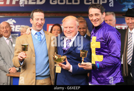 L'entraîneur de Lord Windermere Jim Culloty (l) célèbre avec le propriétaire Dr. Lambe (au centre) et le jockey Davy Russell après avoir remporté la coupe d'or Betfred Cheltenham Steeple Chase Banque D'Images