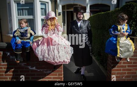 Les enfants juifs orthodoxes célèbrent le festival de Purim dans les rues de Stamford Hill, dans le nord de Londres. Le jour férié qui commémore la délivrance du peuple juif dans l'ancien Empire Perse de la destruction à la suite d'un complot de Haman, Une histoire enregistrée dans le Livre biblique d'Esther est marquée par des parties dans lesquelles les enfants portent des costumes habillés de fantaisie et prennent des cadeaux à des amis voisins et à la famille. Banque D'Images