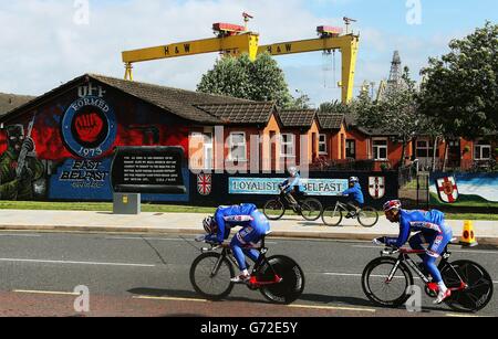 Deux jeunes cyclistes observent les membres de l'équipe de FDJ.fr qui se rendent sur la route Newtownards à Belfast lors de la séance d'essais en temps d'équipe avant la première étape du Giro d'Italia de 2014. Banque D'Images