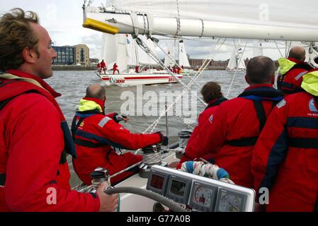 L'équipage du Clipper de Glasgow navigue à travers la flotte au début de la course Clipper 2002 Round the World Yacht, à l'Albert Dock de Liverpool.La première étape de la course de 11 mois a été reportée de 24 heures en raison de vents violents.* laisser les huit bateaux identiques assis au port avant de courir à Cascais au Portugal.De là, ils continueront sur Cuba, Hawaï, Hong Kong, Maurice et New York.Les équipages sont composés de marins amateurs qui ont subi un programme d'entraînement de rigore pour participer à la course la plus longue du monde. Banque D'Images