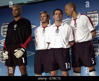 Joueurs, de gauche à droite : le gardien de but David James, David Beckham, Michael Owen et Rio Ferdinand portent la nouvelle piste de football de l'Angleterre pour 2003-5 mar, dans un hôtel de Londres. Banque D'Images