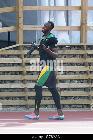 La Jamaïque Usain Bolt prend des photos lors d'une séance d'entraînement sur la piste d'échauffement à côté du parc Hampden, pendant les Jeux du Commonwealth de 2014 à Glasgow. Banque D'Images