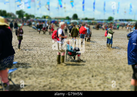 Glastonbury Festival 2016 a vu le pire dans l'histoire du festival de boue mais il n'a pas empêché ces amateurs de musique trouver une petite île dans une mer de boue pour s'asseoir et regarder leurs actes préférés. Banque D'Images