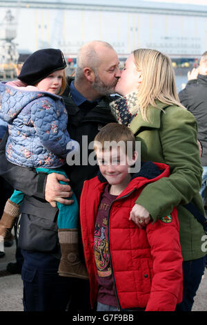 Le sous-marin Steven panniers est accueilli par sa famille après avoir débarqué du HMS astute à la base navale de HM Clyde, en Écosse, à la suite du déploiement de la jeune fille des sous-marins en février, où il a contribué à la présence du Royaume-Uni en Méditerranée. Banque D'Images