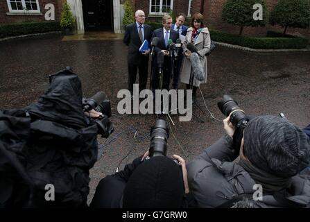 Un Taoiseach Enda Kenny (deuxième à gauche) accompagné (de gauche à droite) du ministre des Affaires étrangères Charlie Flanagan, Sean Sherlock du ministre d'État au ministère des Affaires étrangères et Tanaiste Joan Burton s'entretient avec les médias à leur arrivée à Stormont House, Belfast, avant les discussions politiques avec les politiciens locaux. Banque D'Images