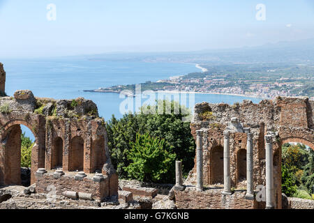 Ancien théâtre grec de Taormina ville avec un panorama vers le sud à l'île sicilienne et la Mer Méditerranée Banque D'Images