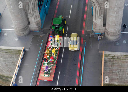 Un tracteur livre un troupeau de Shaun the Sheep à Londres en prévision du lancement de Shaun in the City ce week-end, un sentier artistique unique avec des sculptures de cinq pieds de haut du personnage de créations Aardman, qui ont été conçues par des célébrités pour la Fondation Wallace and Gromit pour enfants. Banque D'Images