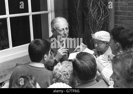 Le premier ministre Harold Macmillan signe des autographes pour les supporters à l'extérieur de sa maison à Birch Grove, Chelwood Gate, Sussex. Le terrain et certaines des chambres du rez-de-chaussée où le premier ministre a rencontré le président Kennedy le week-end dernier, ont été ouverts au public à l'aide de la retraite des infirmières de district. Banque D'Images