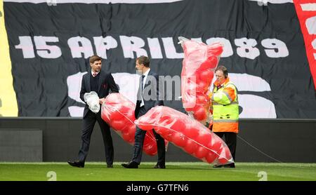 Le capitaine de Liverpool Steven Gerrard (à gauche) et le capitaine d'Everton Phil Jagielka (au centre) libèrent 96 ballons lors du service commémoratif Hillsborough à Anfield, Liverpool, pour marquer le 26e anniversaire de la catastrophe de Hillsborough, Comme ils se rappellent les 96 supporters de Liverpool qui sont morts dans un écrasement au stade Hillsborough de Sheffield mercredi le 15 1989 avril, où Liverpool devait rencontrer Nottingham Forest dans une demi-finale de la coupe FA. Banque D'Images