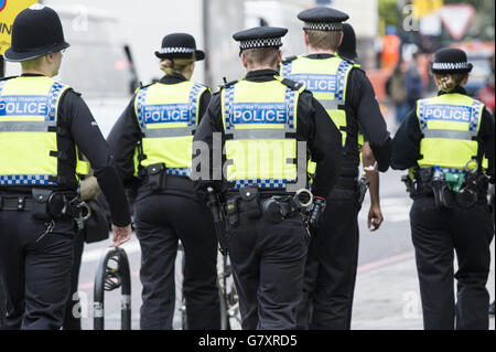 Six agents de la police britannique des transports patrouillent dans la rue à Highbury, à Londres. Banque D'Images