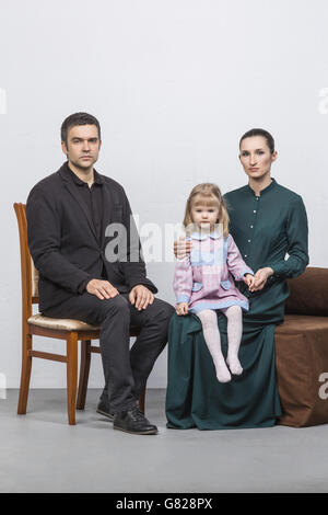 Portrait of family sitting against white background Banque D'Images