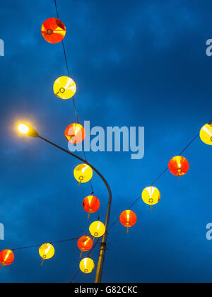 Low angle view of illuminated lampions hanging against sky Banque D'Images