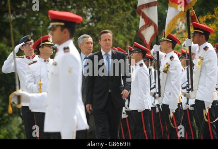 Le Premier ministre David Cameron inspecte une garde d'honneur alors qu'il est accueilli au Palais présidentiel par le Premier ministre singapourien Lee Hsien Loong. Banque D'Images