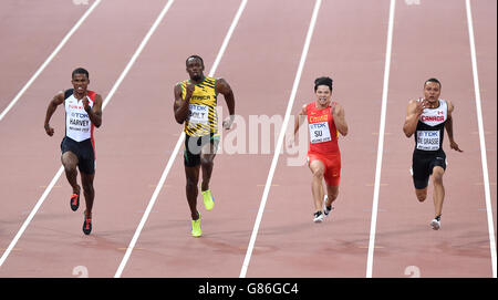 (De gauche à droite) Jak Ali Harvey, de la Turquie, Usain Bolt en Jamaïque, Bingtian su en Chine et André de Grasse, du Canada, participent à la compétition de 100 mètres de chaleur 1 pour les hommes, au cours du deuxième jour des championnats du monde de l'IAAF au stade national de Beijing, en Chine. Banque D'Images