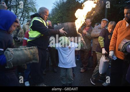 Un enfant du village du Devonshire d'Ottery St Mary porte le Tar Barrel traditionnel dans les rues du village la nuit de Bonfire. Banque D'Images