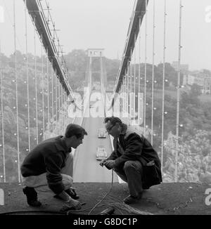 Le pont suspendu de Clifton de 245 mètres de haut, enjambant la gorge Avon à Bristol, est orné d'un tableau festif en l'honneur du nouveau pont Severn, qui relie l'Angleterre et le pays de Galles et qui sera ouvert demain par la reine Elizabeth II. Ici, la dernière des 4,000 ampoules électriques du pont suspendu Clifton est fixée par Brian Parke (l), de Bath, et Ray You'd, de Bristol. Banque D'Images