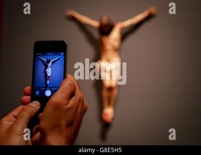 Berlin, Allemagne. 29 Juin, 2016. Un visiteur prend des photos de l'objet 'le Christ sur la croix' par l'artiste espagnol Luisa Ignacia Roldan à la Gemäldegalerie art museum à Berlin, Allemagne, 29 juin 2016. Le 'El Siglo de Oro. L' ère Velazquez exposition qui aura lieu du 01 juillet au 30 octobre 2016 mettra l'accent sur l'âge d'or de l'art espagnol Photo : KAY NIETFELD/dpa/Alamy Live News Banque D'Images