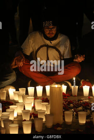 Les foules se rassemblent pour observer les hommages floraux et les bougies laissées à la place de la République, après les attaques terroristes de vendredi soir. Banque D'Images