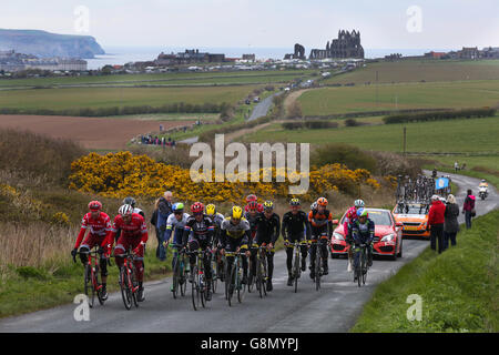 Le peloton, avec la célèbre abbaye derrière eux, en fait c'est sortir de Whitby, dans la dernière étape du Tour de Yorkshire. Banque D'Images