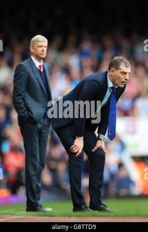 Arsene Wenger, gestionnaire de l'arsenal, et Slaven Bilic, gestionnaire de West Ham United, lors du match de la Barclays Premier League à Upton Park, Londres. Banque D'Images