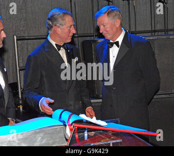 Le Prince de Galles reçoit un opus sur Manchester United par Sir Alec Ferguson (à droite) lors de la soirée de gala pour célébrer le travail de Princes Trust qui s'est tenu au Roundhouse de Camden, au nord de Londres. Banque D'Images