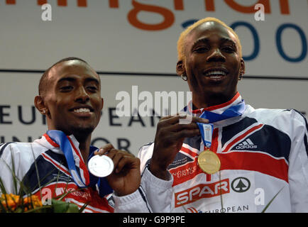 Phillips Idowu, lauréat de la médaille d'or en Grande-Bretagne, et Nathan Douglas, médaillé d'argent (à gauche) après l'épreuve de triple saut aux championnats d'athlétisme en salle européens à la National Indoor Arena, Birmingham. Banque D'Images