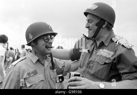 Se détendre dans leur période de repos avec une pause légère à bord du HMS Hermes en route vers les Malouines sont le chef Petty Officer Raymond Mason, 37 ans, à gauche, et le chirurgien CDR Neville Scholes déguisés en généraux américains. Banque D'Images