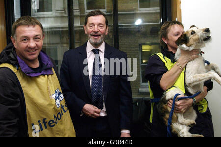 L'ancien ministre David Blunkett, au centre, rit alors que le chien-guide Havoc, à droite, continue de grogner quand il a été amené à voir David Blunkett dans son bureau par Paul Barber, à gauche, et Wendy Barthard lors de leurs 5000 miles autour de Britain Coastal Charity Walk, pour les chiens-guides pour aveugles et les RNLI. Banque D'Images