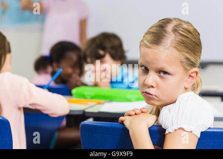 Portrait de l'écolière triste assis dans la salle de classe Banque D'Images