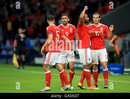 Pays de Galles' Ashley Williams (deuxième à droite) célèbre marquant son but premier du côté du jeu avec ses coéquipiers Gareth Bale (droite), Hal Robson-Kanu (deuxième à gauche) et James Chester (à gauche) au cours de l'UEFA Euro 2016, trimestre dernier match au Stade Pierre Mauroy, Lille. Banque D'Images