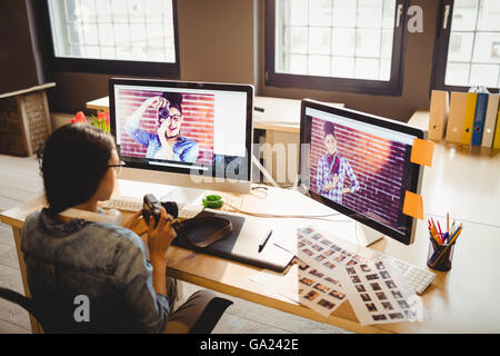 Graphic Designer holding digital camera