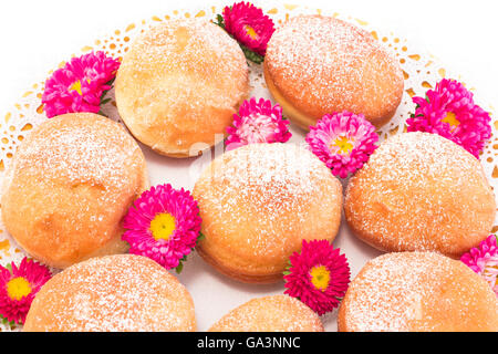 Beignets faits maison décorée de fleurs. Banque D'Images