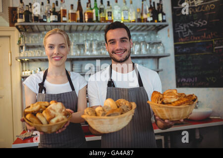 Young workers avec du pain frais dans des paniers Banque D'Images