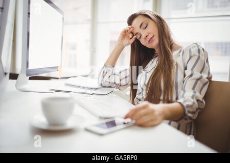 Businesswoman relaxing in creative office Banque D'Images