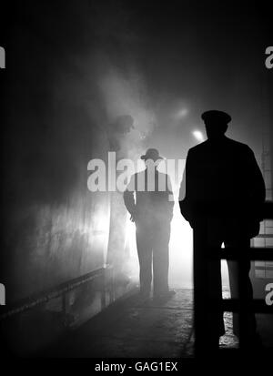 Le conducteur du moteur du train de bateau « Queen Mary » reçoit des instructions de dernière minute de la part du superviseur de la gare de Waterloo, avant de partir sur son trajet brumeux à destination de Southampton. Banque D'Images