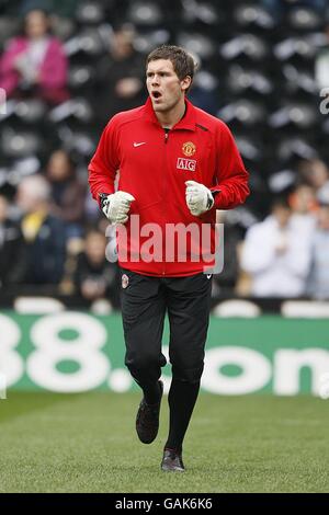 Ben Foster, gardien de but de Manchester United, se réchauffe avant le coup de pied arrêt Banque D'Images