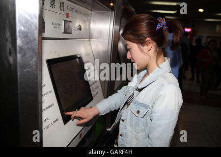 Une femme chinoise est à l'aide d'une machine d'acheter un billet pour le métro à la station de métro Zhongshan. Shanghai, Chine. 30.04.2016. Banque D'Images